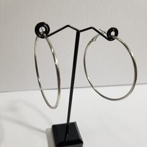 Silver tone hoop earrings pierce two inches